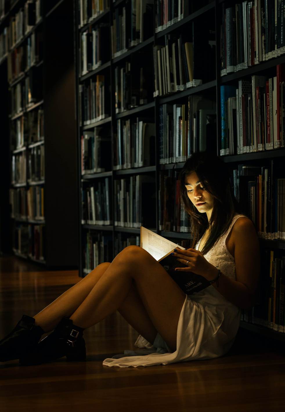 Woman Leaning On Bookshelf, Reading